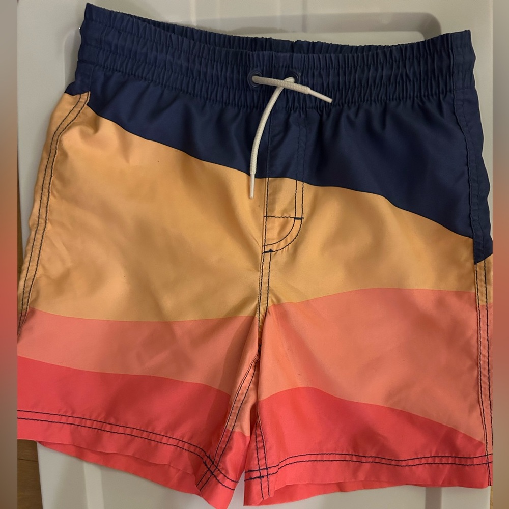 Old Navy, coral and navy colored swim trunks. Boy’s size 10–12